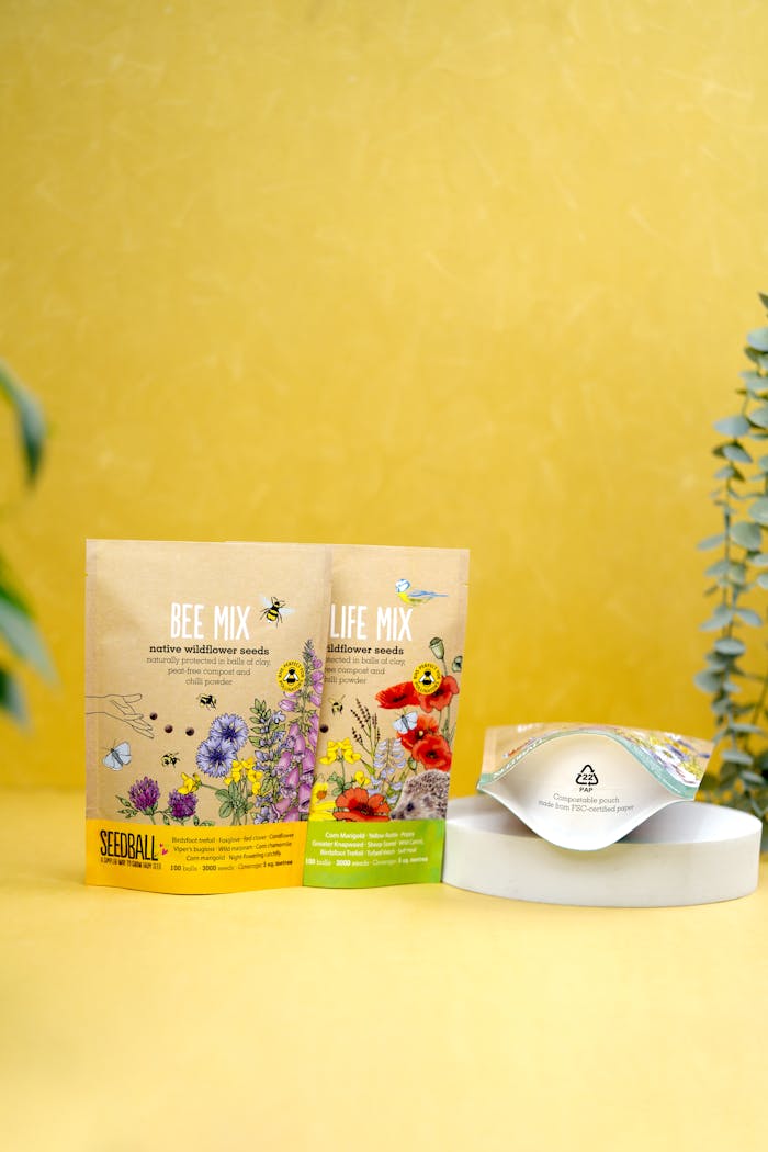 about-02 Vibrant wildflower seed packages with eco-friendly packaging on a yellow backdrop.